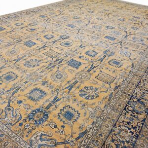 Close-up view of a vintage blue and gold floral pattern rug by Rugs On Net. by Rugs On Net