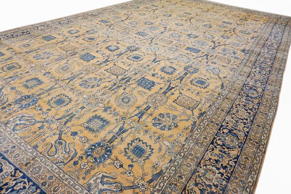 Close-up view of a vintage blue and gold floral pattern rug by rugs on net. By rugs on net