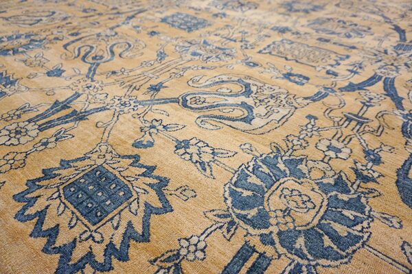 Close-up of a tan and blue floral patterned rug by rugs on net. By rugs on net