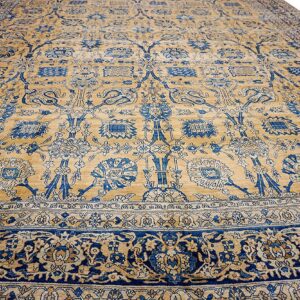 Close-up of a tan and blue floral rug design by Rugs On Net