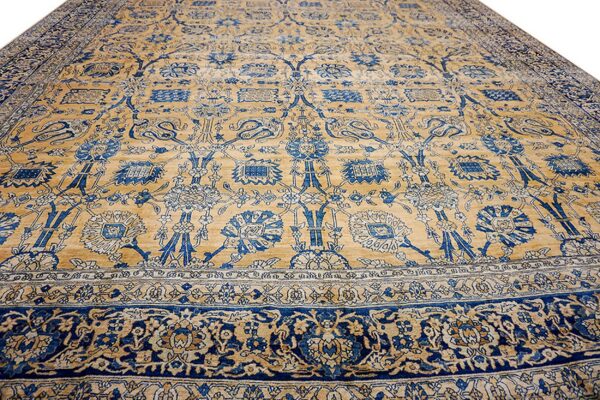 Close-up of a tan and blue floral rug design by rugs on net