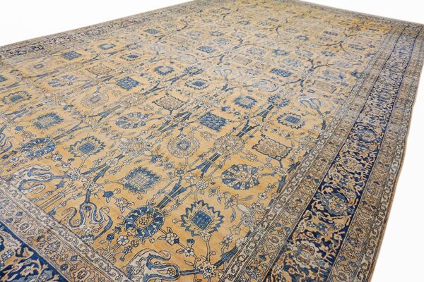Close-up view of a gold and blue patterned area rug by rugs on net. By rugs on net