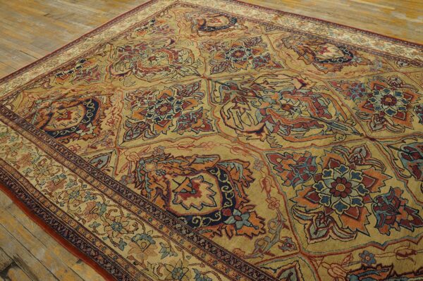 Close-up of a richly patterned, gold-toned area rug with floral motifs in red and blue by rugs on net. By rugs on net