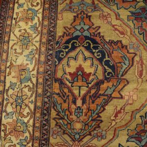 Close-up of an ornate Oriental rug pattern featuring gold, red, and blue motifs by Rugs On Net