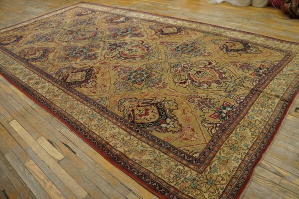 A large, traditional area rug with a gold field and intricate floral medallions, by rugs on net. By rugs on net