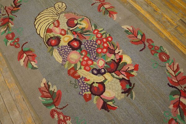 Close-up of a hooked rug featuring a colorful cornucopia overflowing with fruits and surrounded by colorful leaves on a gray background, by rugs on net. By rugs on net