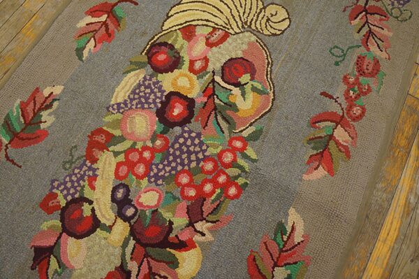 Close-up of a colorful floral and fruit motif on a gray hooked rug by rugs on net. By rugs on net