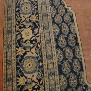 Close-up of a prayer rug border design featuring dark blue, beige, and teal floral motifs by Rugs On Net