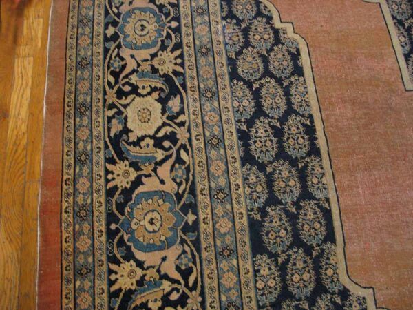 Close-up of a prayer rug border design featuring dark blue, beige, and teal floral motifs by rugs on net