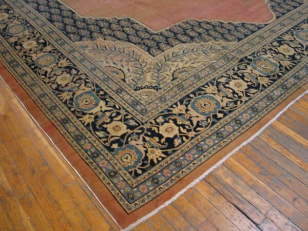 Close-up of an ornate persian rug border with navy and gold detailing by rugs on net