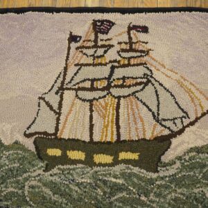 Hooked rug depicting a sailing ship on choppy seas, American flag visible, by Rugs On Net
