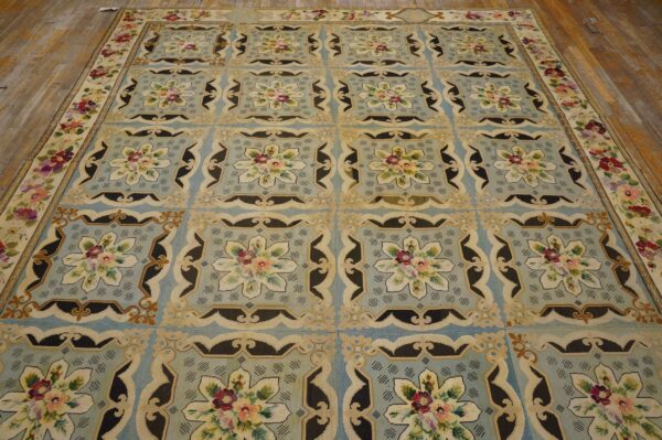 A light blue rug with repeating floral medallions in cream and dark accents, by rugs on net. By rugs on net