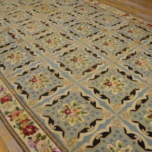 A light blue rug with repeating floral medallions and black accents, by Rugs On Net