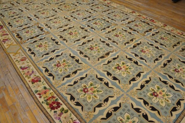 A light blue rug with repeating floral medallions and black accents, by rugs on net