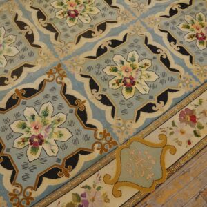 Close-up of a needlepoint rug with blue field and floral medallions by Rugs On Net