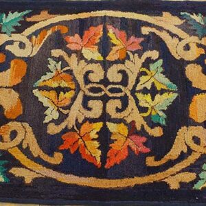 A dark blue rug featuring an ornate scrollwork design with colorful autumn leaves, by Rugs On Net. by Rugs On Net
