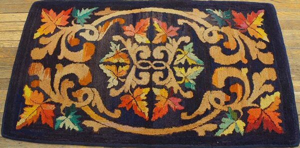 A dark blue rug featuring an ornate scrollwork design with colorful autumn leaves, by rugs on net. By rugs on net