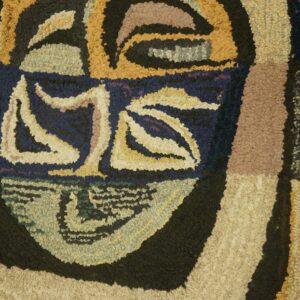 Close-up of a textured, abstract face design on the 'Tribal Mask Rug' by Rugs On Net. by Rugs On Net