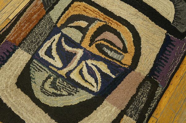 Close-up of an abstract, colorful hooked rug design on a wood floor by rugs on net. By rugs on net