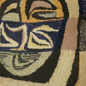 Close-up of a colorful, abstract, hooked rug design resembling a face, by Rugs On Net. by Rugs On Net