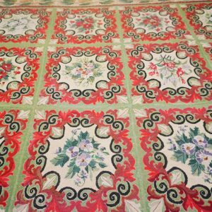 Close-up of a green and red floral tapestry rug design by Rugs On Net