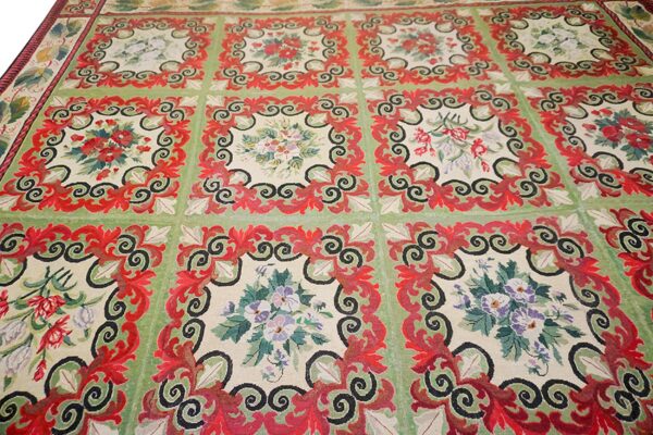 Close-up of a green and red floral tapestry rug design by rugs on net