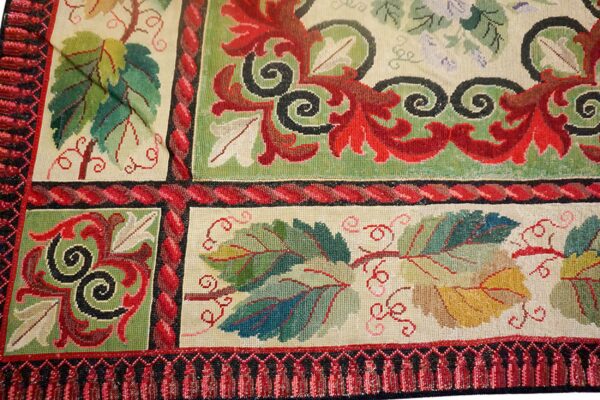 Detail of a tapestry rug featuring colorful grape leaves and scrolling vines, by rugs on net