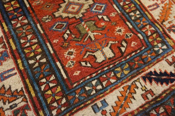Close-up of a vibrant, richly colored antique rug with geometric patterns by rugs on net