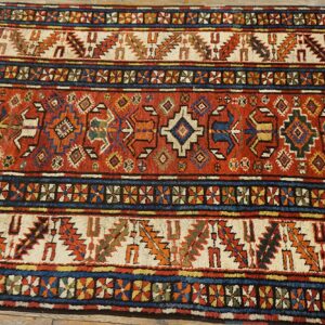 Close-up of a richly colored antique rug with geometric patterns, by Rugs On Net