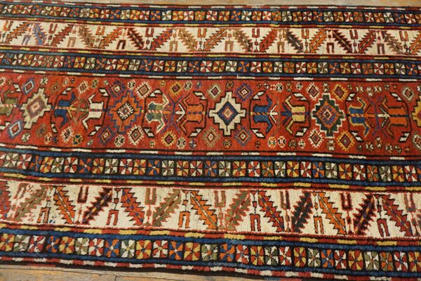 Close-up of a richly colored antique rug with geometric patterns, by rugs on net