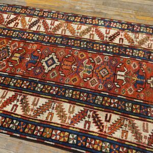 Close-up of a vibrant runner rug with geometric patterns in red, blue, and cream, by Rugs On Net. by Rugs On Net