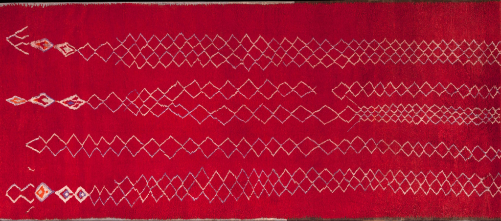 Vibrant red moroccan rug with white geometric diamond lattice patterns and tribal accents by rugs on net