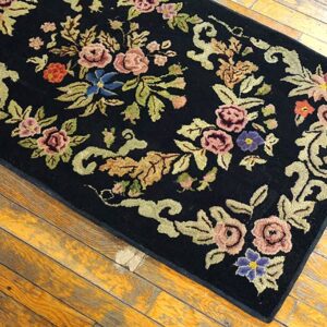 Close-up of a black rug with colorful floral embroidery, by Rugs On Net. by Rugs On Net