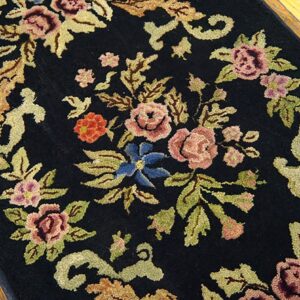 Close-up of a black floral rug with pink and blue flowers by Rugs On Net