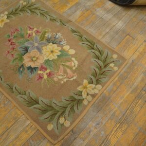 A close-up of a floral hooked rug with pastel colors on a rustic wooden floor, by Rugs On Net. by Rugs On Net