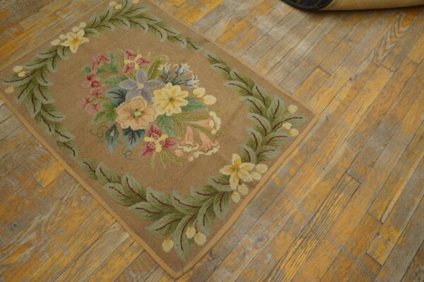 A close-up of a floral hooked rug with pastel colors on a rustic wooden floor, by rugs on net. By rugs on net