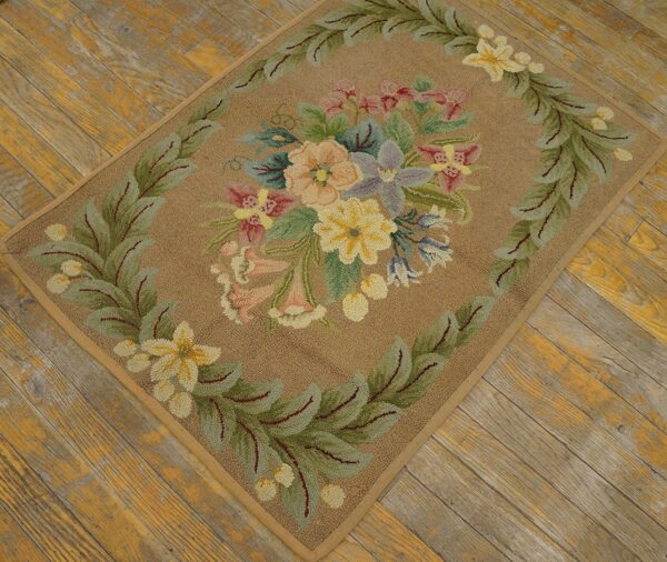 A close-up of the floral bouquet hooked rug on wooden flooring by rugs on net. By rugs on net