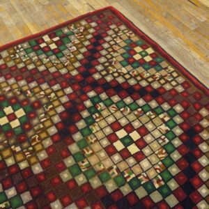 Close-up of a colorful, geometric rug with square patterns on a wooden floor by Rugs On Net