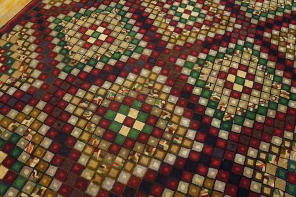 Close-up of a colorful geometric rug with checkerboard squares in reds, greens, and earth tones by rugs on net