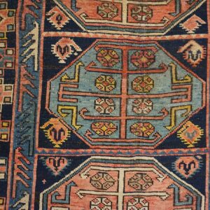 Close-up of geometric patterns and floral motifs in a vintage rug by Rugs On Net