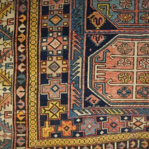 Close-up of geometric patterns and rich colors in the Antique Caucasian Rug by Rugs On Net. by Rugs On Net