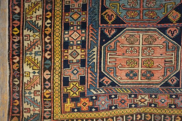 Close-up of geometric patterns and rich colors in the antique caucasian rug by rugs on net. By rugs on net