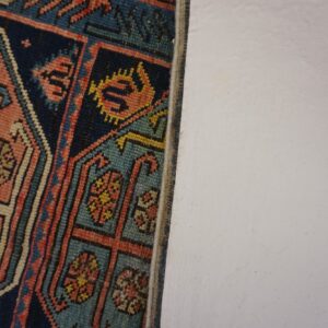 Close-up detail of geometric patterns in a colorful antique rug by Rugs On Net. by Rugs On Net