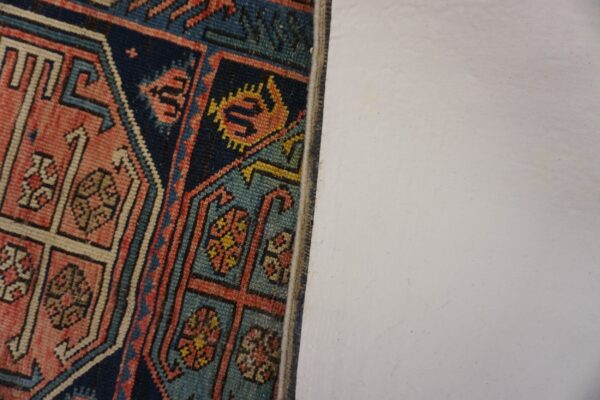 Close-up detail of geometric patterns in a colorful antique rug by rugs on net. By rugs on net