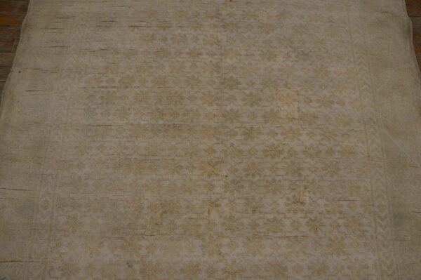 Close-up texture of a faded beige rug with subtle floral patterns by rugs on net. By rugs on net