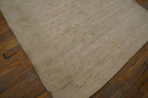 Close-up of a textured, light beige moroccan rug on a wooden floor by rugs on net