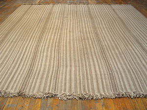 Striped beige kilim rug on wood floor by rugs on net