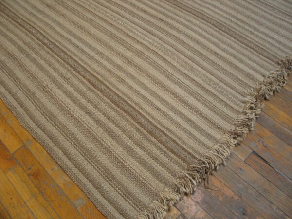 Close-up of a beige striped jute rug on wood floors by rugs on net