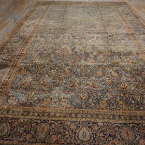 A large, antique Persian rug featuring an all-over paisley pattern on a deep blue field, by Rugs On Net. by Rugs On Net