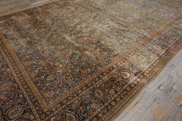 Close-up of a richly patterned, antique persian rug featuring dense paisley motifs on a dark blue field, by rugs on net
